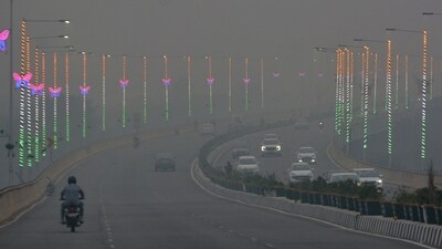Smoky haze engulfs a road in the National Capital Region. (PTI) Smoky haze engulfs a road in the National Capital Region. (PTI)
