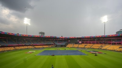 Groundsmen cover the pitch ahead of the ICC Men's Cricket World Cup 2023 match between New Zealand and Pakistan, at M. Chinnaswamy Stadium (PTI) Groundsmen cover the pitch ahead of the ICC Men's Cricket World Cup 2023 match between New Zealand and Pakistan, at M. Chinnaswamy Stadium (PTI)