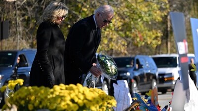 US President Joe Biden and First Lady Jill Biden pays their respects outside Schemengees Bar and Grille in Lewiston, Maine, on November 3, 2023 following a mass shooting on October 25. (AFP) US President Joe Biden and First Lady Jill Biden pays their respects outside Schemengees Bar and Grille in Lewiston, Maine, on November 3, 2023 following a mass shooting on October 25. (AFP)
