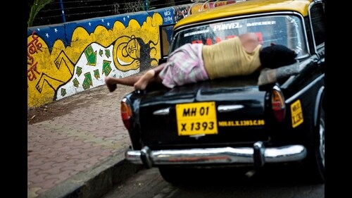 A photograph of a taxi driver taking an off-duty nap atop his Padmini in Lower Parel, made by the author in 2010. (Aparna Jayakumar)