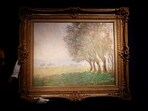 A Drouot employee poses with the painting "Les Saules, Giverny, 1886" (The Willows, Giverny), by painter Claude Monet (1840-1926) ahead of its auction at Drouot auction house in Paris, France, 