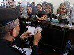 Palestinians with dual nationality register to cross into Egypt on the Gaza Strip side of the Rafah border crossing. (AP) Palestinians with dual nationality register to cross into Egypt on the Gaza Strip side of the Rafah border crossing. (AP)
