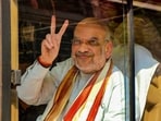 Union home minister Amit Shah shows a victory sign as he arrives to campaign for the upcoming assembly elections in Madhya Pradesh in Shivpuri district on November 4,