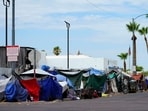 FILE - Tents line the street of "The Zone," a homeless encampment, Tuesday, July 11, 2023, in Phoenix.  The City of Phoenix said it has successfully cleared out a massive downtown homeless encampment by Saturday, Nov. 4, court ordered deadline by helping more than 500 people find beds in shelters and motels. 