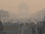 Commuters out on a smoggy morning amid rising air pollution at Kartavya Path in New Delhi 