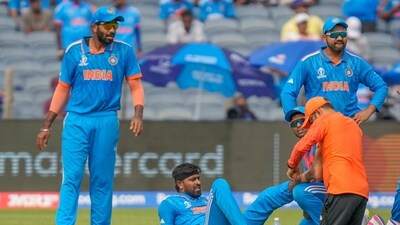Team physio attends to India's Hardik Pandya, second left, after sustaining an injury during the ICC Men's Cricket World Cup match between India and Bangladesh in Pune (AP) Team physio attends to India's Hardik Pandya, second left, after sustaining an injury during the ICC Men's Cricket World Cup match between India and Bangladesh in Pune (AP)