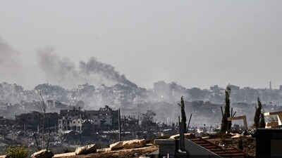 A picture taken from the southern Israeli border city of Sderot shows smoke rising above buildings in the Gaza Strip during an Israeli strike (AFP)