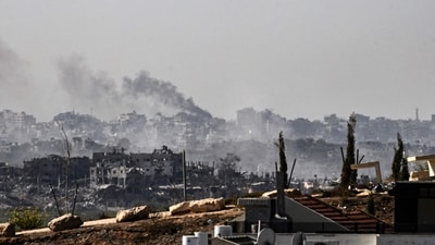 A picture taken from the southern Israeli border city of Sderot shows smoke rising above buildings in the Gaza Strip during an Israeli strike (AFP)