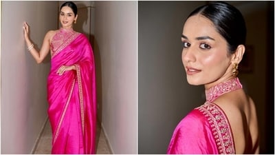Manushi Chhillar's Rani pink silk saree features a patti border adorned in golden-coloured intricate embroidery and sequin embellishments. She draped the six yards in traditional style, letting the pallu fall from her shoulder elegantly and pleats done neatly on the front. A sleeveless halter-neck blouse featuring a backless design, fitted silhouette, cropped hem, knot closure on the back, and heavy golden embellishments completed the look. (Instagram) Manushi Chhillar's Rani pink silk saree features a patti border adorned in golden-coloured intricate embroidery and sequin embellishments. She draped the six yards in traditional style, letting the pallu fall from her shoulder elegantly and pleats done neatly on the front. A sleeveless halter-neck blouse featuring a backless design, fitted silhouette, cropped hem, knot closure on the back, and heavy golden embellishments completed the look. (Instagram)