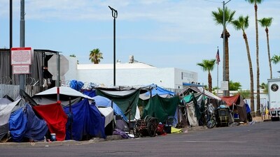 FILE - Tents line the street of "The Zone," a homeless encampment, Tuesday, July 11, 2023, in Phoenix. The City of Phoenix said it has successfully cleared out a massive downtown homeless encampment by Saturday, Nov. 4, court ordered deadline by helping more than 500 people find beds in shelters and motels. (AP) FILE - Tents line the street of "The Zone," a homeless encampment, Tuesday, July 11, 2023, in Phoenix. The City of Phoenix said it has successfully cleared out a massive downtown homeless encampment by Saturday, Nov. 4, court ordered deadline by helping more than 500 people find beds in shelters and motels. (AP)