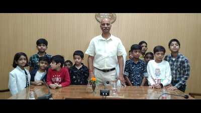 UPPSC chairman Sanjay Shrinet with children of UPPSC officials on Saturday (HT Photo)