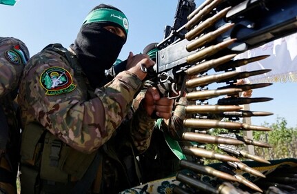 A Palestinian fighter from the armed wing of Hamas takes part in a military parade to mark the anniversary of the 2014 war with Israel, near the border in the central Gaza Strip, July 19, 2023. (Reuters)