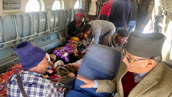 Nepal Prime Minister, Pushpa Kamal Dahal speaks to rescued people inside a helicopter after an earthquake in Jajarkot, Nepal.(REUTERS)