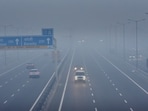 Commuters out on a smoggy morning amid rising air pollution levels at Delhi Meerut Expressway. 