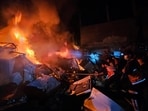 Palestinians try to put out a fire at the site of an Israeli strike on a house in Jabalia refugee camp on the northern Gaza Strip on November 4.