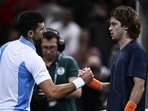 Winner Serbia's Novak Djokovic shakes hands with Andrey Rublev after their men's singles semi-final match on day six of the Paris ATP Masters 1000 tennis tournament 