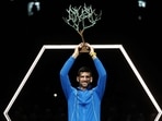 Novak Djokovic celebrates with the trophy after winning his men's singles final match against Bulgaria's Grigor Dimitrov