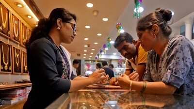 FILE PHOTO: People shop for gold ornaments at a jewellery showroom during Dhanteras, a Hindu festival associated with Lakshmi, the goddess of wealth, in Mumbai, India, October 22, 2022. REUTERS/Niharika Kulkarni/File Photo