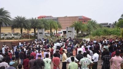 People gather after an explosion that killed a woman and injured several others, at a convention centre in Kochi. (PTI)