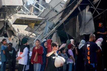 Palestinian women line up to buy fresh bread next to destroyed buildings at the Nuseirat refugee camp in the central Gaza Strip on November 4, 2023, amid ongoing battles between Israel and the militant group Hamas. (AFP) Palestinian women line up to buy fresh bread next to destroyed buildings at the Nuseirat refugee camp in the central Gaza Strip on November 4, 2023, amid ongoing battles between Israel and the militant group Hamas. (AFP)