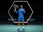 Serbia's Novak Djokovic celebrates with the trophy after winning his men's singles final match against Bulgaria's Grigor Dimitrov 