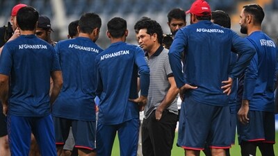 Sachin Tendulkar speaks with Afghanistan players during a practice session on the eve of their 2023 ICC Men's Cricket World Cup match against Australia at the Wankhede Stadium in Mumbai (AFP)