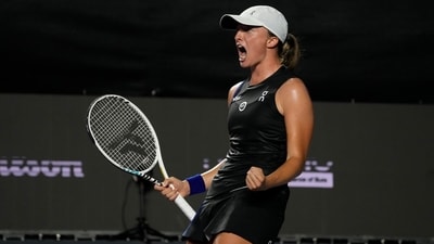 Iga Swiatek, of Poland, celebrates after defeating Aryna Sabalenka, of Belarus, during a women's singles semifinal match at the WTA Finals tennis championships, in Cancun (AP)