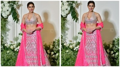 Sara Ali Khan looked stunning in a pink and silver lehenga featuring a plunging neckline blouse. She opted for a minimalistic approach to jewelry and styled her hair in an elegant bun. (HT Photo) Sara Ali Khan looked stunning in a pink and silver lehenga featuring a plunging neckline blouse. She opted for a minimalistic approach to jewelry and styled her hair in an elegant bun. (HT Photo)
