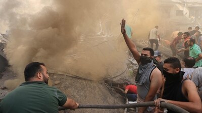 Israel-Hamas War: Palestinians sift through the rubble of a building in Khan Yunis amid the ongoing battles between Israel and Hamas. (AFP) Israel-Hamas War: Palestinians sift through the rubble of a building in Khan Yunis amid the ongoing battles between Israel and Hamas. (AFP)