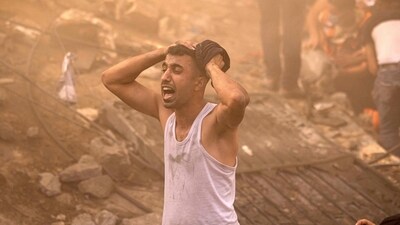 Israel-Hamas War: A Palestinian man reacts as others check the rubble of a building in Khan Yunis. (AFP)