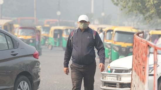 A man wears a mask to protect himself from growing level of air pollution in New Delhi on Monday. (PTI)