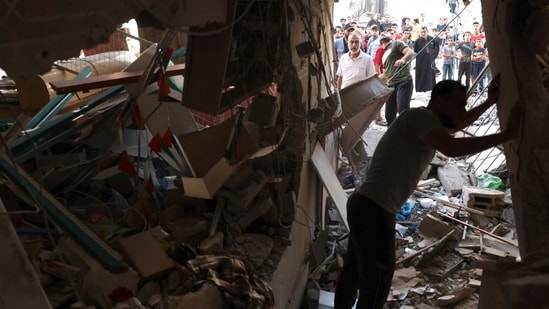 Israel-Hamas War: People inspect the rubble of a building in Rafah in the southern Gaza Strip. (AFP)