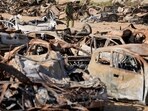 An Israeli soldier inspects charred vehicles burned in the bloody Oct. 7 cross-border attack by Hamas