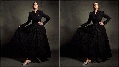 Her ensemble consisted of a black blazer with commanding power shoulders, full sleeves, a buttoned bodice and an elegant diamond brooch adorning the side. She paired it with a flared maxi skirt with intricate floral detailing. (Instagram/@sonamkapoor) Her ensemble consisted of a black blazer with commanding power shoulders, full sleeves, a buttoned bodice and an elegant diamond brooch adorning the side. She paired it with a flared maxi skirt with intricate floral detailing. (Instagram/@sonamkapoor)