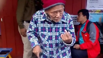 An elderly voter shows his inked finger after casting his vote for Mizoram Assembly Elections at a polling booth in Aizawl. (ANI)