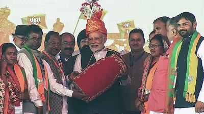 Prime Minister Narendra Modi being felicitated during a public meeting for the Chhattisgarh Assembly elections in Surajpur. (ANI)