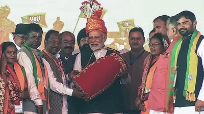 PM Modi being felicitated during a public meeting for the Chhattisgarh Assembly elections in Surajpur. (ANI) PM Modi being felicitated during a public meeting for the Chhattisgarh Assembly elections in Surajpur. (ANI)
