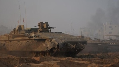 Israel-Hamas War: Israeli soldiers and military vehicles take position inside the Gaza Strip, amid the ongoing ground operation of the Israeli army. (Reuters)