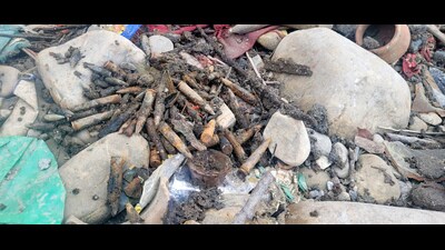 Jammu and Kashmir police recover live rounds along the Jammu-Pathankot highway during cleaning of a pond, in Samba on Tuesday. (ANI)