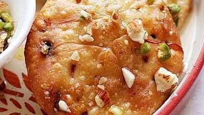 Mawa Kachori (Rajasthan): Hailing from Jodhpur, Rajasthan, this delectable dish offers a sweeter twist on the traditional salted kachori. It features a filling of mawa/khoya, mixed dry fruits, and is delicately dipped in a sugar syrup, creating a delightful dessert. (Pinterest) Mawa Kachori (Rajasthan): Hailing from Jodhpur, Rajasthan, this delectable dish offers a sweeter twist on the traditional salted kachori. It features a filling of mawa/khoya, mixed dry fruits, and is delicately dipped in a sugar syrup, creating a delightful dessert. (Pinterest)