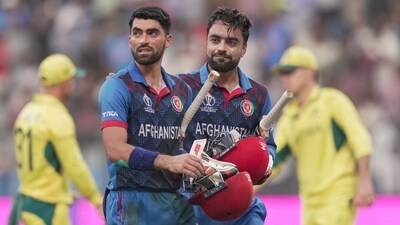 Afghanistan's Ibrahim Zadran and Rashid Khan walk towards the pavilion after the inning during the ICC Men's Cricket World Cup 2023 match (PTI) Afghanistan's Ibrahim Zadran and Rashid Khan walk towards the pavilion after the inning during the ICC Men's Cricket World Cup 2023 match (PTI)