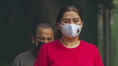 People wear face masks while on a morning walk at a park in New Delhi. (PTI Photo) People wear face masks while on a morning walk at a park in New Delhi. (PTI Photo)