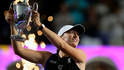 Poland's Iga Swiatek raisess her trophy on the podium after winning the WTA Finals Championship women's singles final tennis match in Cancun, Mexico (AFP) Poland's Iga Swiatek raisess her trophy on the podium after winning the WTA Finals Championship women's singles final tennis match in Cancun, Mexico (AFP)