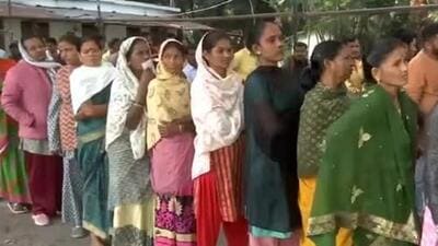 Voters queue up outside a polling booth in Kondagaon in Chhattisgarh as they await their turn to cast a vote in the first phase of assembly elections. (ANI)