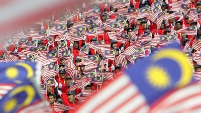 Malaysians wave the national flags during Malaysia Day celebrations in Kuala Lumpur. (File Photo) Malaysians wave the national flags during Malaysia Day celebrations in Kuala Lumpur. (File Photo)