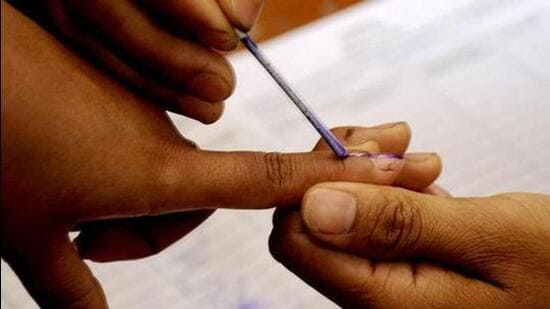 A polling official marks a voter with indelible ink. (AFP File Photo)