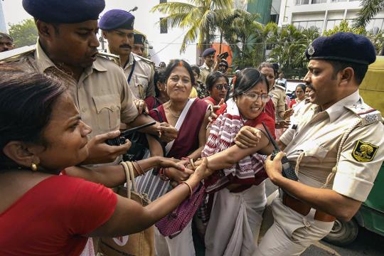 Security personnel in a scuffle with Anganwadi workers protesting outside the Bihar Legislative Assembly, in Patna, Tuesday (PTI) Security personnel in a scuffle with Anganwadi workers protesting outside the Bihar Legislative Assembly, in Patna, Tuesday (PTI)
