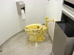 The 18-karat toilet, titled "America," by Maurizio Cattelan in the restroom of the Solomon R. Guggenheim Museum in New York. 