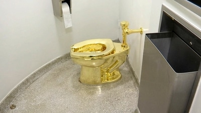 The 18-karat toilet, titled "America," by Maurizio Cattelan in the restroom of the Solomon R. Guggenheim Museum in New York. (AP)