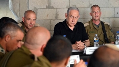 Israeli Prime Minister Benjamin Netanyahu meets with soldiers as he visits an Israeli army base in Tze'elim, Israel November 7, 2023. (via REUTERS)